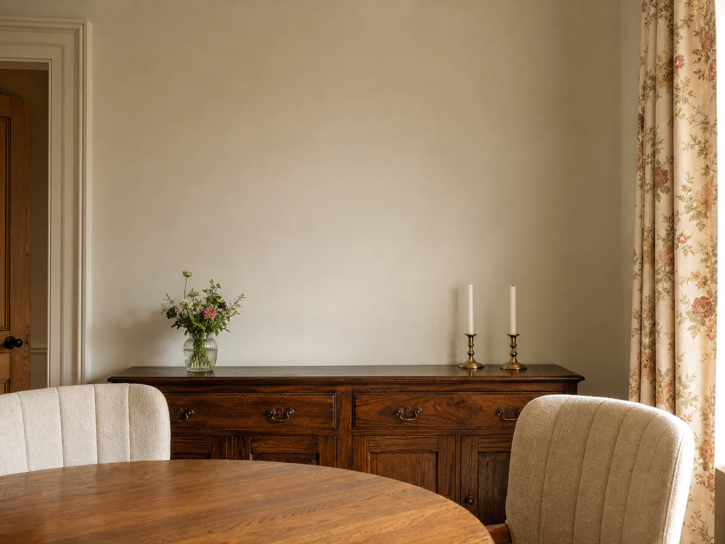 A much-loved British dining room with a portrait above an oak sideboard